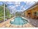 Inviting screened pool area with a spa and ample lounging space, perfect for outdoor enjoyment at 4818 88Th E St, Bradenton, FL 34211