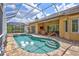 Screened pool and patio area features a beautiful in-ground pool, outdoor seating, and a tiled patio at 4818 88Th E St, Bradenton, FL 34211