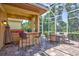 Poolside outdoor kitchen and dining area with a screened enclosure and lush greenery in the background at 4818 88Th E St, Bradenton, FL 34211