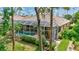 A refreshing screened-in pool offering a private backyard oasis with mature trees and lush greenery at 4818 88Th E St, Bradenton, FL 34211