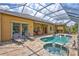 Screened pool and patio area features an in-ground pool, lawn chairs, an outdoor dining set, and a tiled patio at 4818 88Th E St, Bradenton, FL 34211
