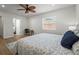 Bright bedroom features wood floors, ceiling fan, and a sunlit window at 515 N Osprey Ave, Sarasota, FL 34236