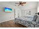 Cozy bedroom with twin beds and a mounted TV at 515 N Osprey Ave, Sarasota, FL 34236