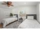 Bedroom featuring twin beds, wood floors, and natural light at 515 N Osprey Ave, Sarasota, FL 34236