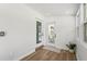Bright entryway featuring wood-look floors, white walls, and a modern glass doors leading to the outdoors at 515 N Osprey Ave, Sarasota, FL 34236