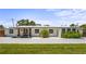 Charming single-story home with a modern design, manicured landscaping, and light gray brick paved driveway at 515 N Osprey Ave, Sarasota, FL 34236