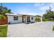 Charming one-story home with a paved driveway, manicured lawn, and a welcoming front entrance at 515 N Osprey Ave, Sarasota, FL 34236