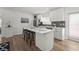 Bright, remodeled kitchen featuring modern appliances, white cabinets, island with bar seating, and backyard access at 515 N Osprey Ave, Sarasota, FL 34236