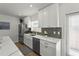 Kitchen with stainless steel appliances, gray backsplash, and white cabinets at 515 N Osprey Ave, Sarasota, FL 34236