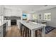 Modern kitchen with an island, stainless steel appliances, and an open floor plan to living and dining areas at 515 N Osprey Ave, Sarasota, FL 34236