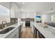 Modern kitchen with marble countertops, stainless steel appliances, an island, and an open-concept layout at 515 N Osprey Ave, Sarasota, FL 34236