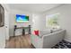 Inviting living room with a mounted TV and contemporary decor, creating a comfortable and stylish space at 515 N Osprey Ave, Sarasota, FL 34236