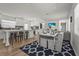 Open-concept living and dining area with barstool seating at the kitchen island and wood-look flooring at 515 N Osprey Ave, Sarasota, FL 34236