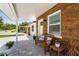 Cozy front porch with wood-look siding, decorative seating, and a paved walkway at 515 N Osprey Ave, Sarasota, FL 34236