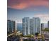 Stunning exterior view of a luxury condominium complex overlooking the waterfront at sunset at 555 Quay Commons # 602, Sarasota, FL 34236