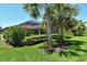 Green backyard with pool view, showcasing the privacy and tropical landscaping at 5968 Snowy Egret Dr, Sarasota, FL 34238