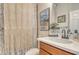 Cozy bathroom featuring a macrame curtain, decorative accents, and a vanity at 5968 Snowy Egret Dr, Sarasota, FL 34238