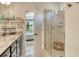 Bright bathroom featuring a glass-enclosed shower, granite counters, and stylish decor at 5968 Snowy Egret Dr, Sarasota, FL 34238