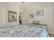 Bedroom featuring a comfortable bed, artwork, and view into another room at 5968 Snowy Egret Dr, Sarasota, FL 34238