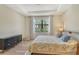 Bedroom with neutral décor, hardwood floors, a large window, and ample closet space at 5968 Snowy Egret Dr, Sarasota, FL 34238