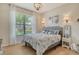 Inviting bedroom with large windows, a comfortable bed, and modern light fixtures at 5968 Snowy Egret Dr, Sarasota, FL 34238