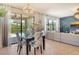 Open dining area with stylish chandelier and views of the lanai and pool at 5968 Snowy Egret Dr, Sarasota, FL 34238