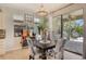 Dining area with a dark wood table, chairs, and view of outdoor kitchen at 5968 Snowy Egret Dr, Sarasota, FL 34238