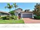 Charming one-story home featuring a tile roof, a two-car garage, and tropical landscaping, offering great curb appeal at 5968 Snowy Egret Dr, Sarasota, FL 34238
