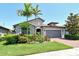Inviting one-story home with tile roof, brick driveway, and lush tropical landscaping offering wonderful curb appeal at 5968 Snowy Egret Dr, Sarasota, FL 34238