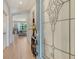 A well-lit foyer featuring a decorative glass front door, tile flooring, and an arched entryway leading to the living area at 5968 Snowy Egret Dr, Sarasota, FL 34238