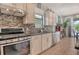 Well-appointed kitchen with stainless steel appliances, tiled backsplash, and ample counter space, designed for both functionality and style at 5968 Snowy Egret Dr, Sarasota, FL 34238