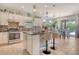 Modern kitchen with an island, stainless steel appliances, and a stylish backsplash, perfect for culinary enthusiasts and entertaining at 5968 Snowy Egret Dr, Sarasota, FL 34238