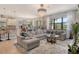 Open-concept living space with a large sectional sofa, view of the kitchen, and seamless flow for easy entertaining at 5968 Snowy Egret Dr, Sarasota, FL 34238
