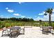 Beautiful patio area with tables and chairs overlooking a peaceful pond and lush greenery at 5968 Snowy Egret Dr, Sarasota, FL 34238