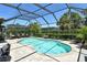 Beautiful screened-in pool area with lush landscaping and comfortable seating at 5968 Snowy Egret Dr, Sarasota, FL 34238