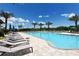 Beautiful community pool with comfortable lounge chairs and lush landscaping at 5968 Snowy Egret Dr, Sarasota, FL 34238
