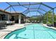 Inviting screened-in pool with seating and dining areas, perfect for outdoor entertaining at 5968 Snowy Egret Dr, Sarasota, FL 34238