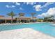 Large community pool with plenty of lounge chairs and a clubhouse in the background at 5968 Snowy Egret Dr, Sarasota, FL 34238