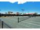 Well-maintained tennis court with professional-grade surface and covered seating area for players at 5968 Snowy Egret Dr, Sarasota, FL 34238