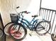 Two bicycles on a balcony with a black metal safety rail. Perfect for enjoying the outdoors at 6157 Midnight Pass Rd # E73, Sarasota, FL 34242