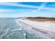 Expansive beachfront showcasing pristine sands and gentle waves, ideal coastal living at 6157 Midnight Pass Rd # E73, Sarasota, FL 34242