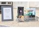 Welcome basket on granite countertop with teas and snacks for new homeowners at 6157 Midnight Pass Rd # E73, Sarasota, FL 34242
