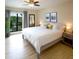 Bright main bedroom with a ceiling fan and large window view at 6157 Midnight Pass Rd # E73, Sarasota, FL 34242