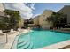 Community pool offering a refreshing retreat surrounded by lush greenery and multiple-story buildings at 6157 Midnight Pass Rd # E73, Sarasota, FL 34242