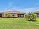 A cozy home with a screened lanai and a well-manicured lawn offers the perfect outdoor retreat at 635 Chipper Dr, Sun City Center, FL 33573