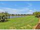 Expansive backyard with a picturesque pond view, offering a serene and scenic outdoor space at 635 Chipper Dr, Sun City Center, FL 33573