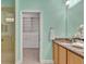 Bathroom featuring a spacious vanity, granite countertops, and walk-in closet at 635 Chipper Dr, Sun City Center, FL 33573