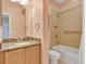 Bathroom features a granite countertop vanity, bathtub with tile surround, and modern fixtures at 635 Chipper Dr, Sun City Center, FL 33573
