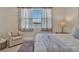 Well-lit bedroom with neutral accents and peaceful view of water at 635 Chipper Dr, Sun City Center, FL 33573