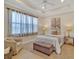 Serene bedroom with soft lighting, a comfortable chair, and light colored decor at 635 Chipper Dr, Sun City Center, FL 33573